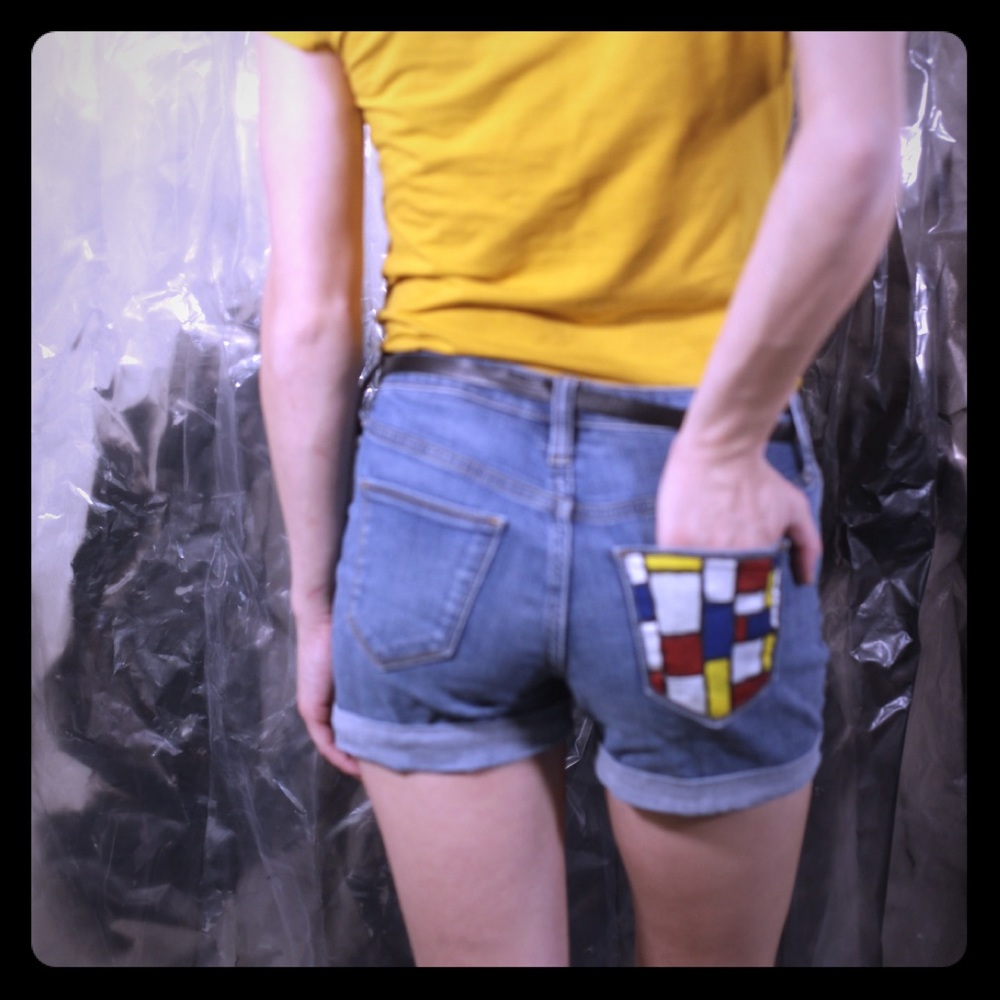Painted shorts with a yellow shirt and black belt